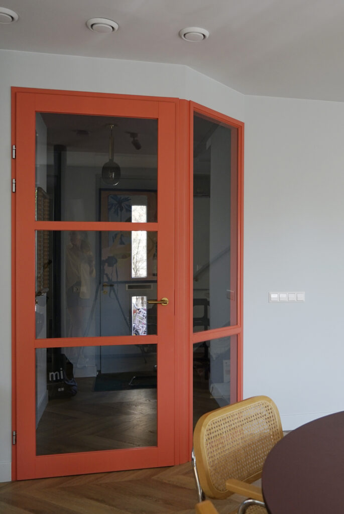 Oranje glazendeuren in de woonkamer.